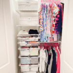 girls closet with clothes hung and pul out baskets labeled